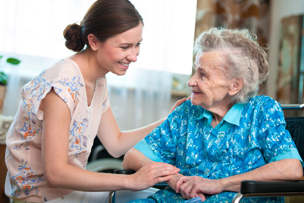 Senior woman with her home caregiver
